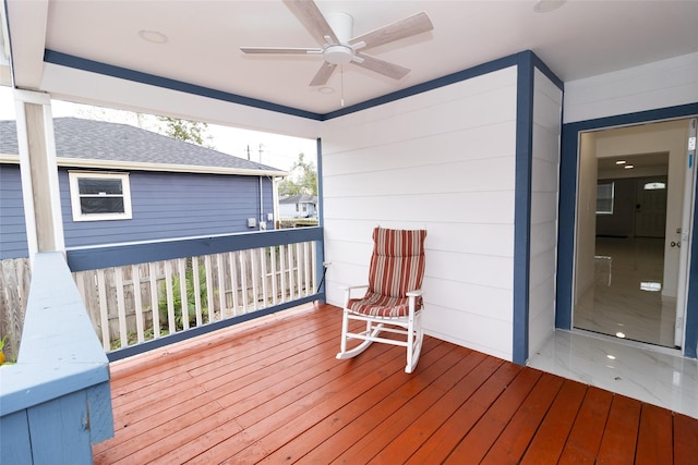 wooden terrace featuring ceiling fan