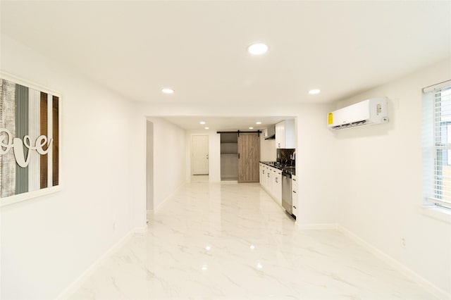 corridor with a barn door and an AC wall unit