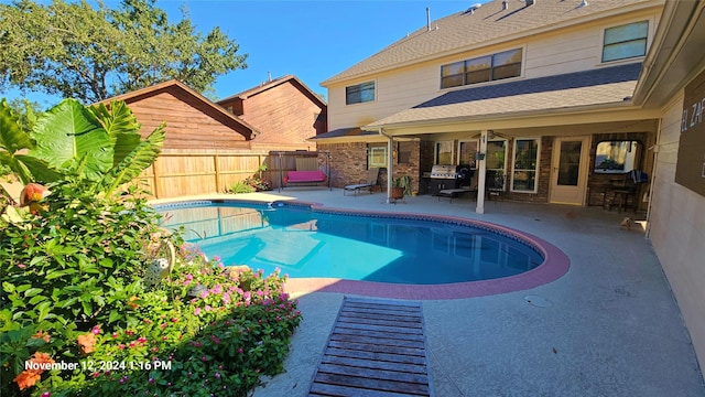 view of swimming pool with a patio area