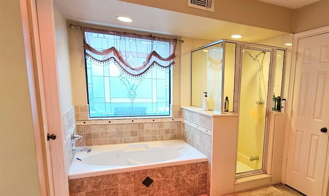 bathroom with tile patterned floors and independent shower and bath