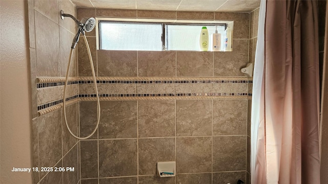 bathroom with a tile shower