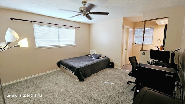 carpeted bedroom with baseboards, a ceiling fan, and a textured ceiling