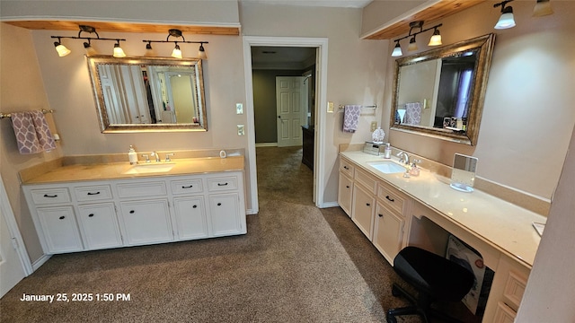 bathroom with two vanities, carpet flooring, and a sink