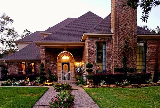 6906 Apple Valley Ln, Houston, TX 77069 - view of front of house featuring a chimney, a shingled roof, and brick siding