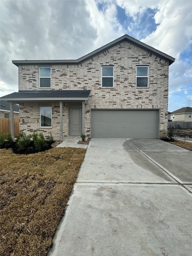 front facade featuring a garage and a front lawn