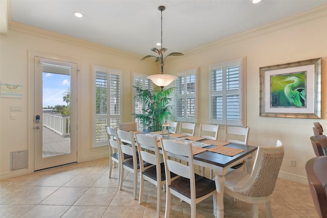 dining room featuring light tile patterned flooring and crown molding