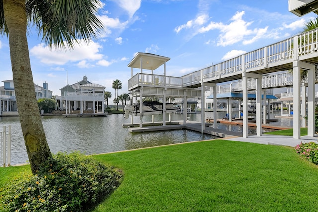 view of dock featuring a water view and a yard