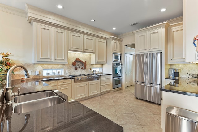 kitchen featuring ornamental molding, sink, cream cabinetry, and stainless steel appliances