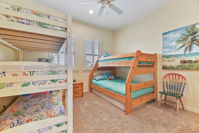 carpeted bedroom with ornamental molding and ceiling fan