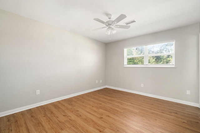 empty room with ceiling fan and light wood-type flooring