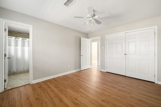 unfurnished bedroom with ceiling fan, a closet, and wood-type flooring