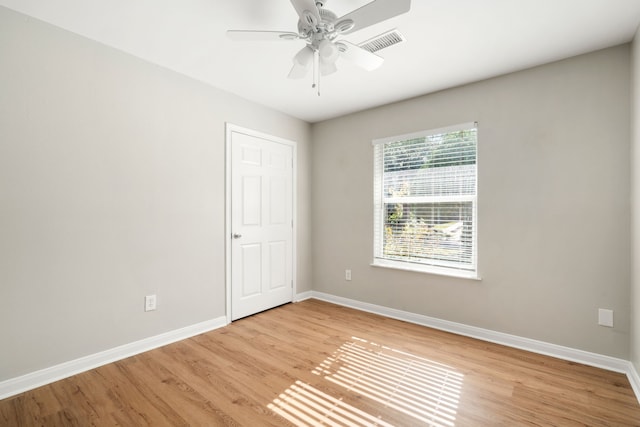 empty room with light hardwood / wood-style flooring and ceiling fan