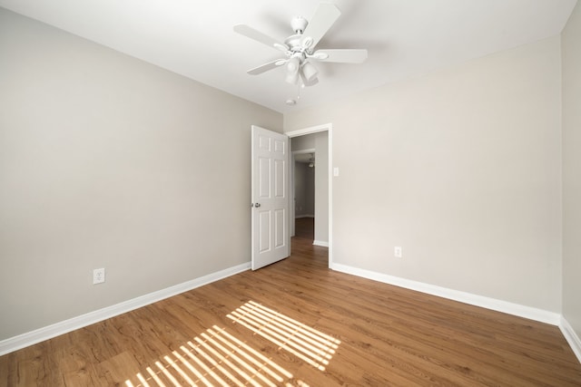 spare room featuring hardwood / wood-style flooring and ceiling fan