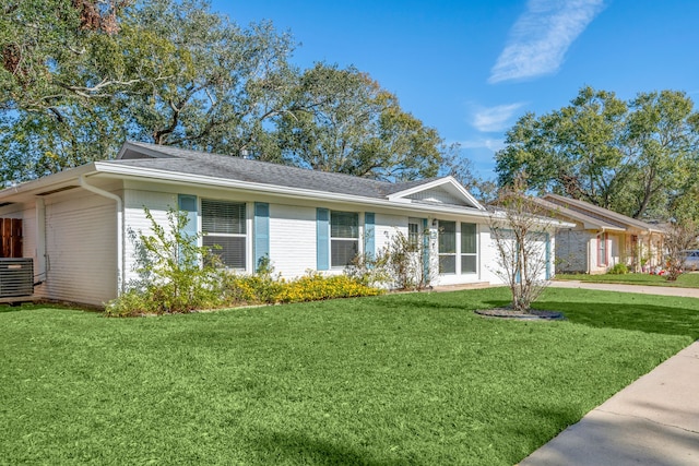 ranch-style home with a front lawn and central AC unit