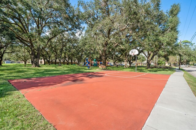 view of sport court featuring a lawn and a playground