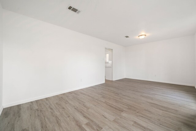 spare room with light hardwood / wood-style flooring