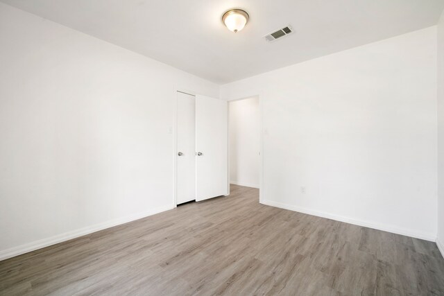 spare room featuring light hardwood / wood-style flooring