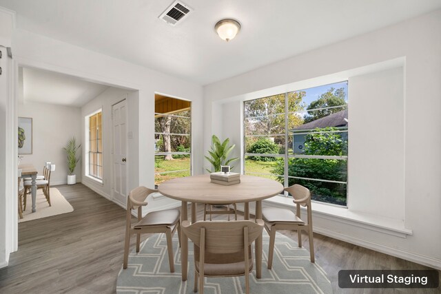 dining space with hardwood / wood-style flooring