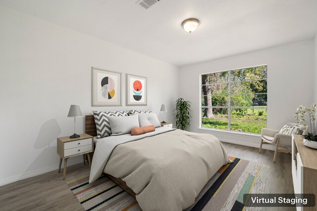 bedroom with hardwood / wood-style floors