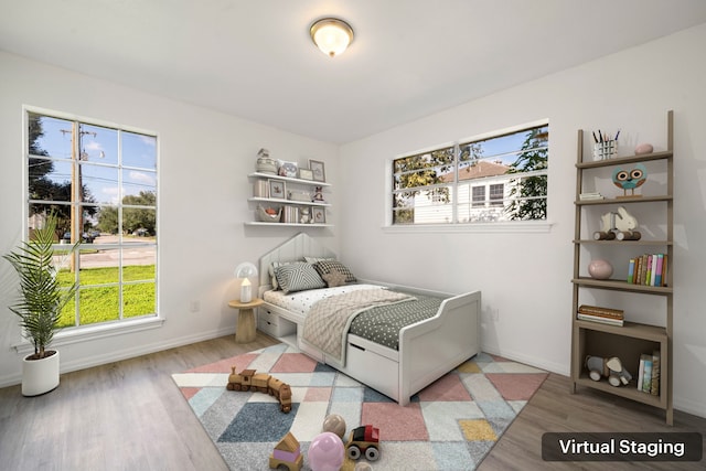 bedroom featuring multiple windows and wood-type flooring