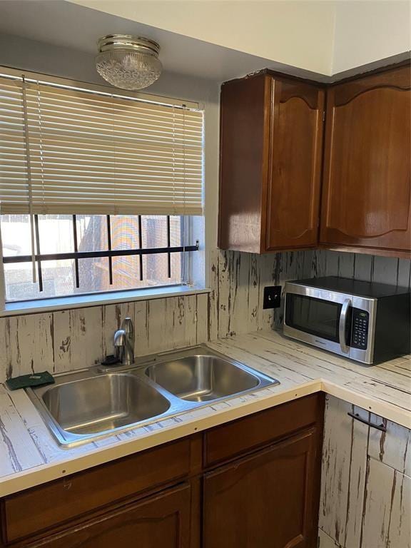 kitchen with plenty of natural light, tasteful backsplash, and sink