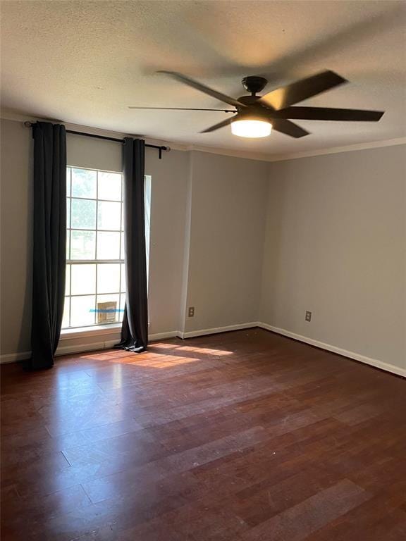 spare room featuring ceiling fan, a textured ceiling, dark hardwood / wood-style floors, and ornamental molding