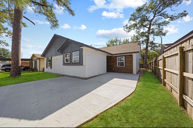 view of front of house featuring a patio and a front lawn