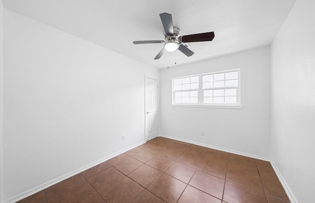 tiled empty room with ceiling fan