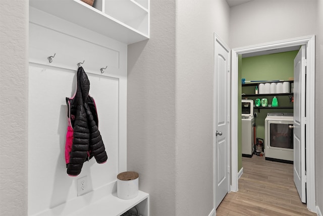 mudroom featuring light wood-type flooring and washer / dryer