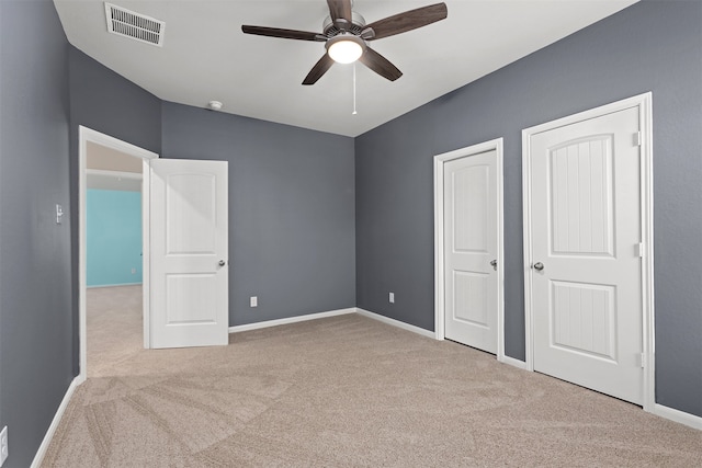 unfurnished bedroom featuring light carpet and ceiling fan