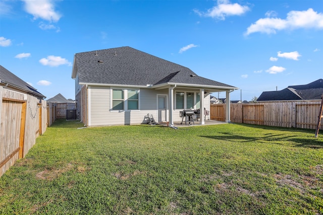 back of house featuring central AC unit, a patio, and a yard