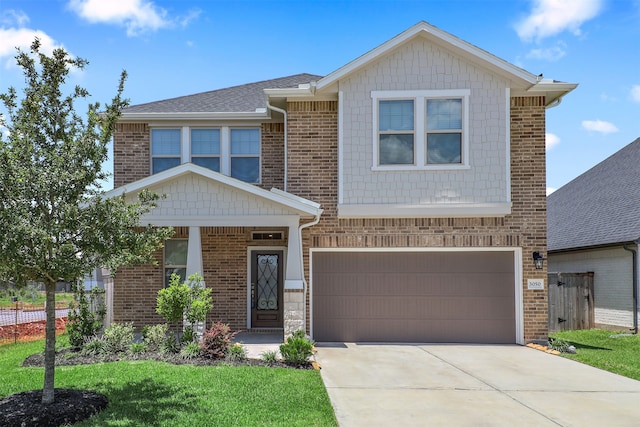 craftsman-style house featuring a front lawn and a garage