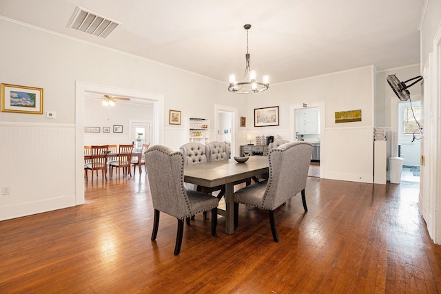 dining area with crown molding, dark hardwood / wood-style floors, and ceiling fan with notable chandelier