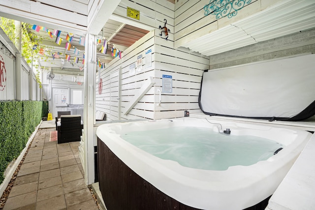 bathroom featuring wooden walls