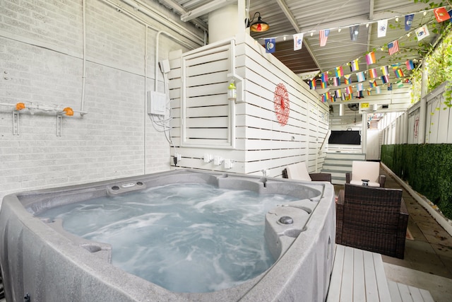 wooden deck featuring a hot tub