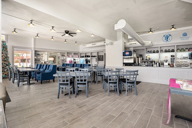 dining space with wood-type flooring and ceiling fan