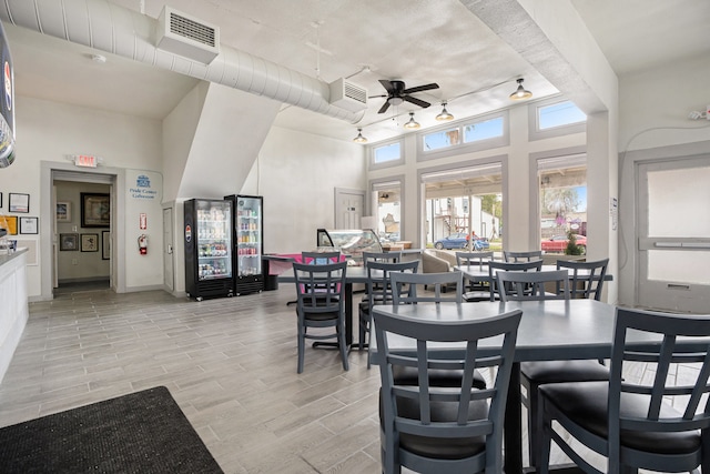 dining space featuring light wood-type flooring, ceiling fan, and track lighting