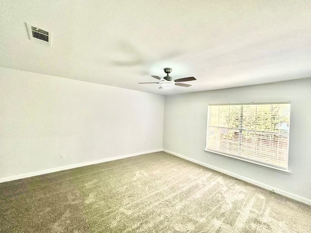 carpeted spare room featuring a textured ceiling and ceiling fan