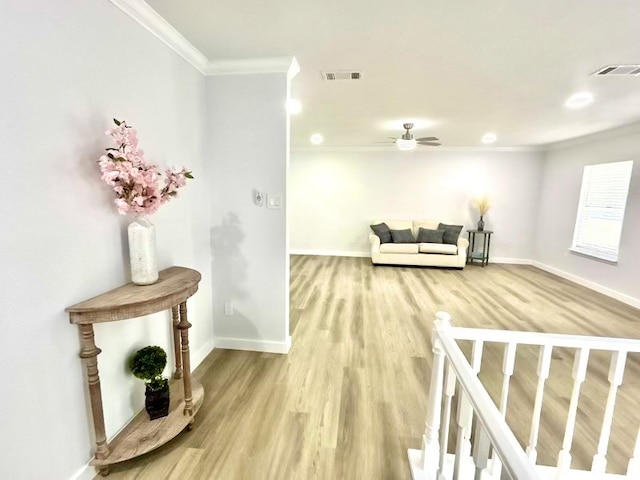 interior space with hardwood / wood-style floors, ceiling fan, and crown molding