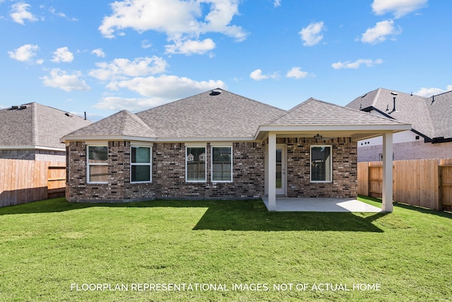 back of property with a lawn, roof with shingles, and a fenced backyard