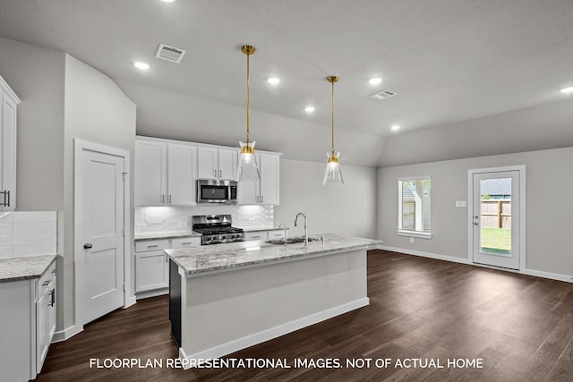 kitchen with visible vents, stainless steel appliances, white cabinetry, pendant lighting, and a sink