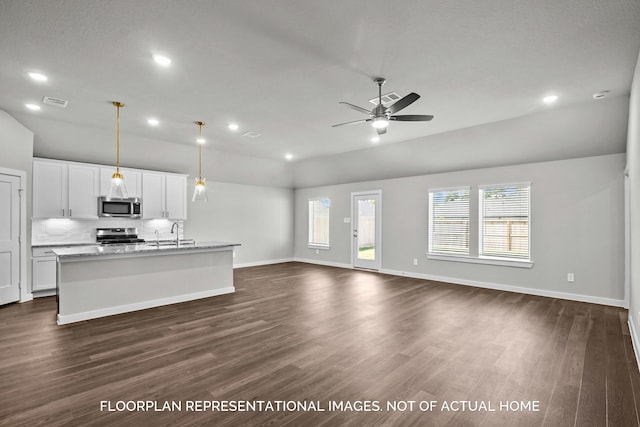 kitchen featuring a kitchen island with sink, stainless steel appliances, white cabinets, open floor plan, and pendant lighting