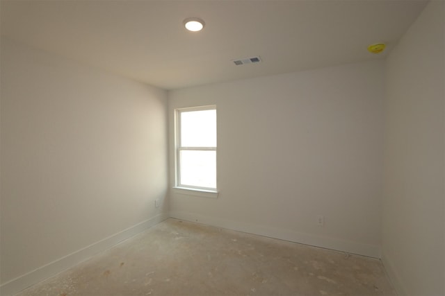 empty room featuring baseboards and visible vents