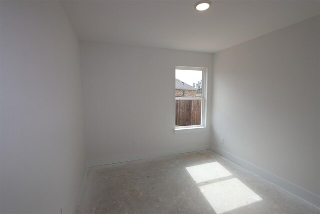 unfurnished room featuring baseboards