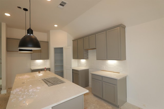 kitchen featuring tasteful backsplash, visible vents, a kitchen island, lofted ceiling, and gray cabinets