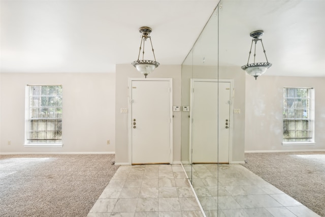 carpeted entryway with plenty of natural light