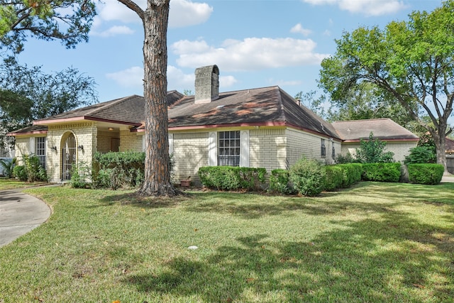 view of side of property with a lawn