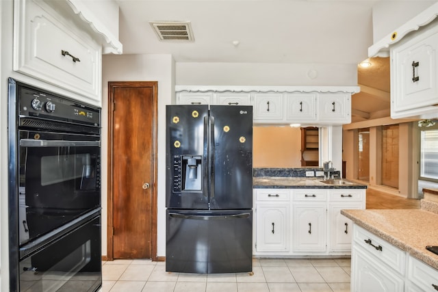 kitchen featuring white cabinets, black appliances, light tile patterned floors, and sink