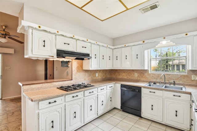 kitchen with black dishwasher, stainless steel gas stovetop, backsplash, and white cabinets