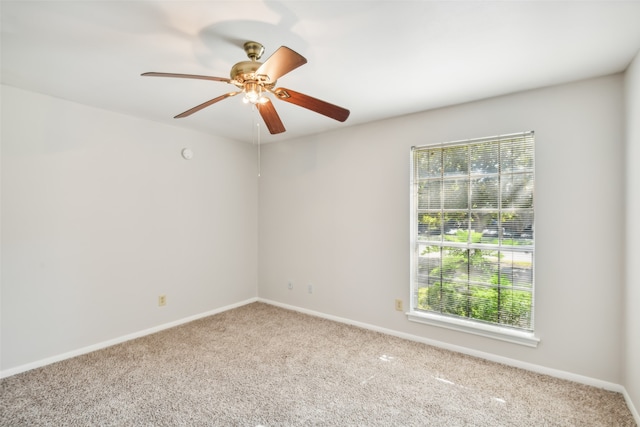 spare room with ceiling fan and light colored carpet